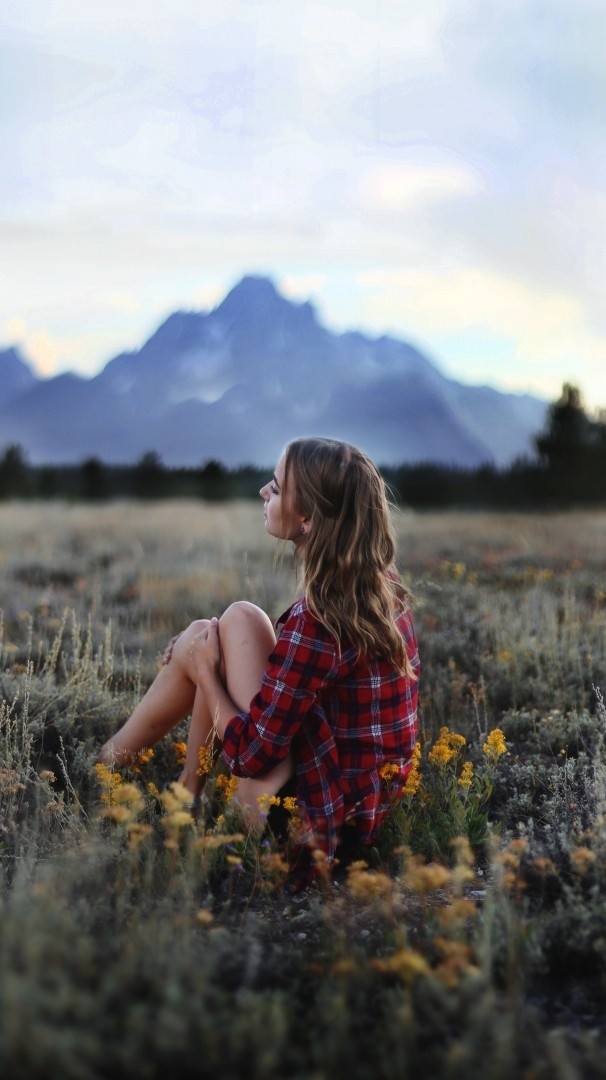 Girl Sitting In Nature Grass Flowers Mountains Iphone Wallpaper