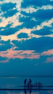 Couple on Sunset Beach iPhone Wallpaper