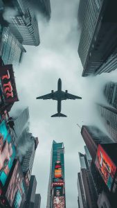 Plane Above Buildings iPhone Wallpaper