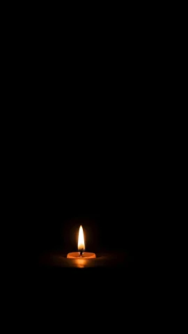 single candle flame dark background peaceful meditation wallpaper