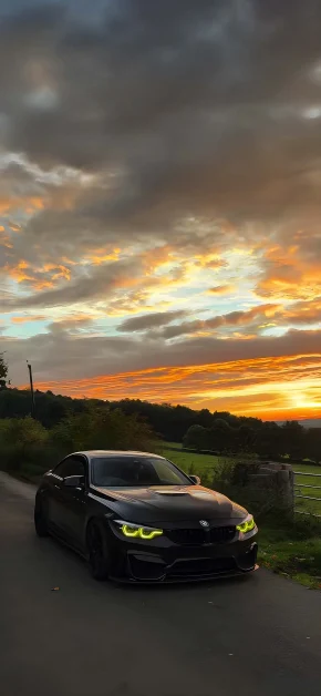 30 Best HD BMW iPhone Wallpapers (4K M Series & Classic) 16 bmw-m4-sunset-green-headlights-iphone-wallpaper